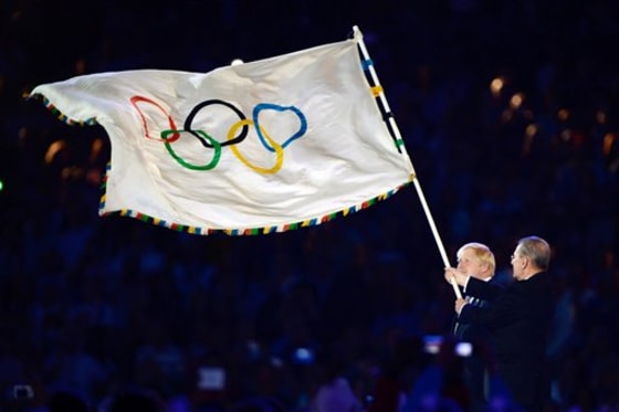 The Olympic flag is handed from London Mayor, Boris Johnson, left, to the International Olympic Committee President Jacques Rogge, during the Closing Ceremony of the 2012 Summer Olympics on Sunday.